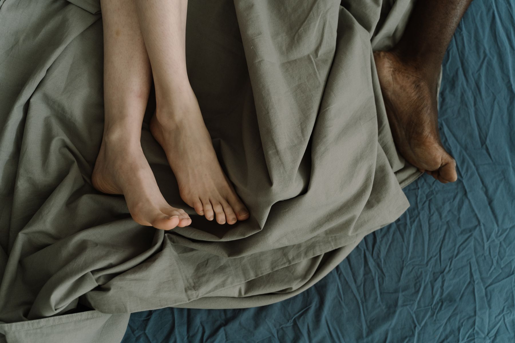 Barefoot couple on bed