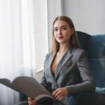 Elegant executive woman in a pinstripe suit pausing before a decision, regret aversion in leadership